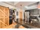 Well-lit kitchen featuring granite countertops, stainless steel appliances, and a stylish sliding barn door at 6213 Willow Ln, Boulder, CO 80301