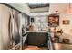 Bright kitchen showcasing stainless steel appliances, dark cabinets, and modern fixtures at 6213 Willow Ln, Boulder, CO 80301