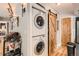 A convenient stacked washer and dryer with a sliding wood door inside the property at 6213 Willow Ln, Boulder, CO 80301