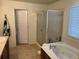 Bathroom with a corner tub and glass enclosed shower at 10636 Racine Cir, Commerce City, CO 80022