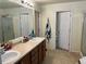 Bathroom with dual sinks and a large mirror at 10636 Racine Cir, Commerce City, CO 80022