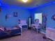 Bright bedroom with blue walls, carpet, and a vanity area with soft, decorative lighting at 10636 Racine Cir, Commerce City, CO 80022