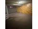 Spacious basement area featuring wood paneling and carpeted floor at 7020 W Portland Ave, Littleton, CO 80128