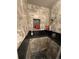 Modern bathroom with stylish tile walls and shelves with shower products at 7020 W Portland Ave, Littleton, CO 80128