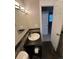 Bathroom featuring a vanity with modern fixtures and a view into an adjoining bedroom at 7020 W Portland Ave, Littleton, CO 80128