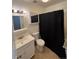 Cozy bathroom featuring a white vanity and toilet, complemented by a black shower curtain at 7020 W Portland Ave, Littleton, CO 80128
