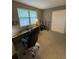 Bedroom with a desk, chair, and guitars creating a multifunctional workspace, well-lit by a large window at 7020 W Portland Ave, Littleton, CO 80128