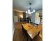 Dining room area featuring wood flooring, a stylish chandelier, and views into the living room at 7020 W Portland Ave, Littleton, CO 80128