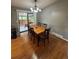 Dining room with wood flooring, stylish chandelier, and sliding glass doors to the patio at 7020 W Portland Ave, Littleton, CO 80128