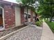 Townhome front featuring well-kept landscaping, a secure screen door, and decorative rock at 7020 W Portland Ave, Littleton, CO 80128