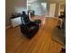 Bright living room featuring wood flooring and a comfortable leather recliner at 7020 W Portland Ave, Littleton, CO 80128