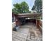 Covered patio with wooden deck and fenced yard at 7020 W Portland Ave, Littleton, CO 80128