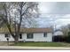Charming single-story home with fresh white paint, a brown shingle roof, and a well-manicured lawn at 5515 Zuni St, Denver, CO 80221