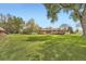Backyard featuring a large manicured lawn and mature trees at 14505 W 52Nd Ave, Arvada, CO 80002