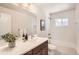 Bright bathroom featuring white tiles and a modern vanity at 14505 W 52Nd Ave, Arvada, CO 80002