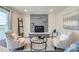 Cozy living room with a gray stone fireplace, plush seating, and natural light at 14505 W 52Nd Ave, Arvada, CO 80002