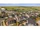 Aerial view of homes featuring well-manicured lawns, landscaping, solar panels, and community amenities at 15201 Yellowthroat St, Parker, CO 80134