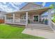 Large back porch with ample seating, a covered area, and an inviting outdoor ambiance at 15201 Yellowthroat St, Parker, CO 80134