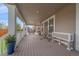 Inviting back porch with outdoor seating, hanging egg chairs, and views of the yard at 15201 Yellowthroat St, Parker, CO 80134