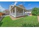 Expansive backyard featuring a covered porch, manicured lawn, and ideal outdoor living space at 15201 Yellowthroat St, Parker, CO 80134