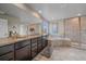 Luxurious bathroom featuring a double vanity, soaking tub, and a walk-in shower at 15201 Yellowthroat St, Parker, CO 80134