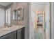 Well-lit bathroom featuring a single sink vanity and a view into the bedroom at 15201 Yellowthroat St, Parker, CO 80134