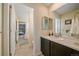 Bright bathroom featuring tile floors, a single vanity and view of another room at 15201 Yellowthroat St, Parker, CO 80134