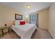 Cozy bedroom featuring a glass side table and natural light from the window at 15201 Yellowthroat St, Parker, CO 80134