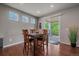 Dining area with a wooden table set, hardwood floors, and sliding glass doors to an outdoor deck at 15201 Yellowthroat St, Parker, CO 80134
