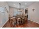Dining room with hardwood floors, modern chandelier, and a view to the kitchen at 15201 Yellowthroat St, Parker, CO 80134
