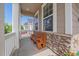 Inviting covered front porch with stone accents and wooden bench seating at 15201 Yellowthroat St, Parker, CO 80134