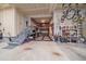 Spacious garage with overhead storage racks and a workspace area with tool organizers and equipment at 15201 Yellowthroat St, Parker, CO 80134
