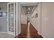 Bright hallway with hardwood floors, decorative lighting, and neutral paint at 15201 Yellowthroat St, Parker, CO 80134
