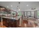 Open-concept kitchen with granite counters, stainless steel appliances, and dark wood cabinets at 15201 Yellowthroat St, Parker, CO 80134