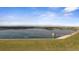 This aerial shot shows a lake with a structure in the distance on a sunny day at 15201 Yellowthroat St, Parker, CO 80134