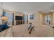Bright living room featuring neutral walls, plush carpet, and a large flat-screen television at 15201 Yellowthroat St, Parker, CO 80134