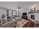 Comfortable living room featuring hardwood floors, a fireplace, and plush seating at 15201 Yellowthroat St, Parker, CO 80134