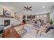 Open-concept living room featuring a fireplace, hardwood floors, and open kitchen at 15201 Yellowthroat St, Parker, CO 80134