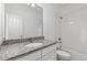 Clean bathroom with white subway tiles, granite countertop, and bathtub at 3037 Lake Helen Blvd, Mead, CO 80542