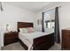 Bedroom with a wooden bed frame, window, and carpet flooring at 3037 Lake Helen Blvd, Mead, CO 80542