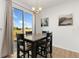 Bright dining area with sliding glass doors leading to backyard at 3037 Lake Helen Blvd, Mead, CO 80542