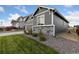 Side view of the house, showcasing gray siding and stone accents at 3037 Lake Helen Blvd, Mead, CO 80542