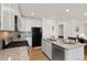 Kitchen island with granite countertop and stainless steel dishwasher at 3037 Lake Helen Blvd, Mead, CO 80542