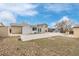 Large backyard featuring a concrete patio, mature trees, and plenty of space for outdoor entertaining at 5542 Sable St, Denver, CO 80239