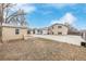 Spacious backyard with sheds, concrete patio, lawn and access to the residence at 5542 Sable St, Denver, CO 80239