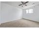 Bedroom featuring carpeting, a ceiling fan, and double-pane window at 5542 Sable St, Denver, CO 80239