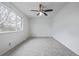 Bright bedroom features a ceiling fan and a large window with natural light at 5542 Sable St, Denver, CO 80239