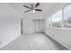 Bright bedroom features a ceiling fan, closet, and large window with natural light at 5542 Sable St, Denver, CO 80239