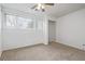 Cozy bedroom with plush carpeting, a ceiling fan, and window at 5542 Sable St, Denver, CO 80239