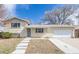 Charming exterior of this home showcasing a well-maintained yard, brick facade, driveway, and attached two-car garage at 5542 Sable St, Denver, CO 80239